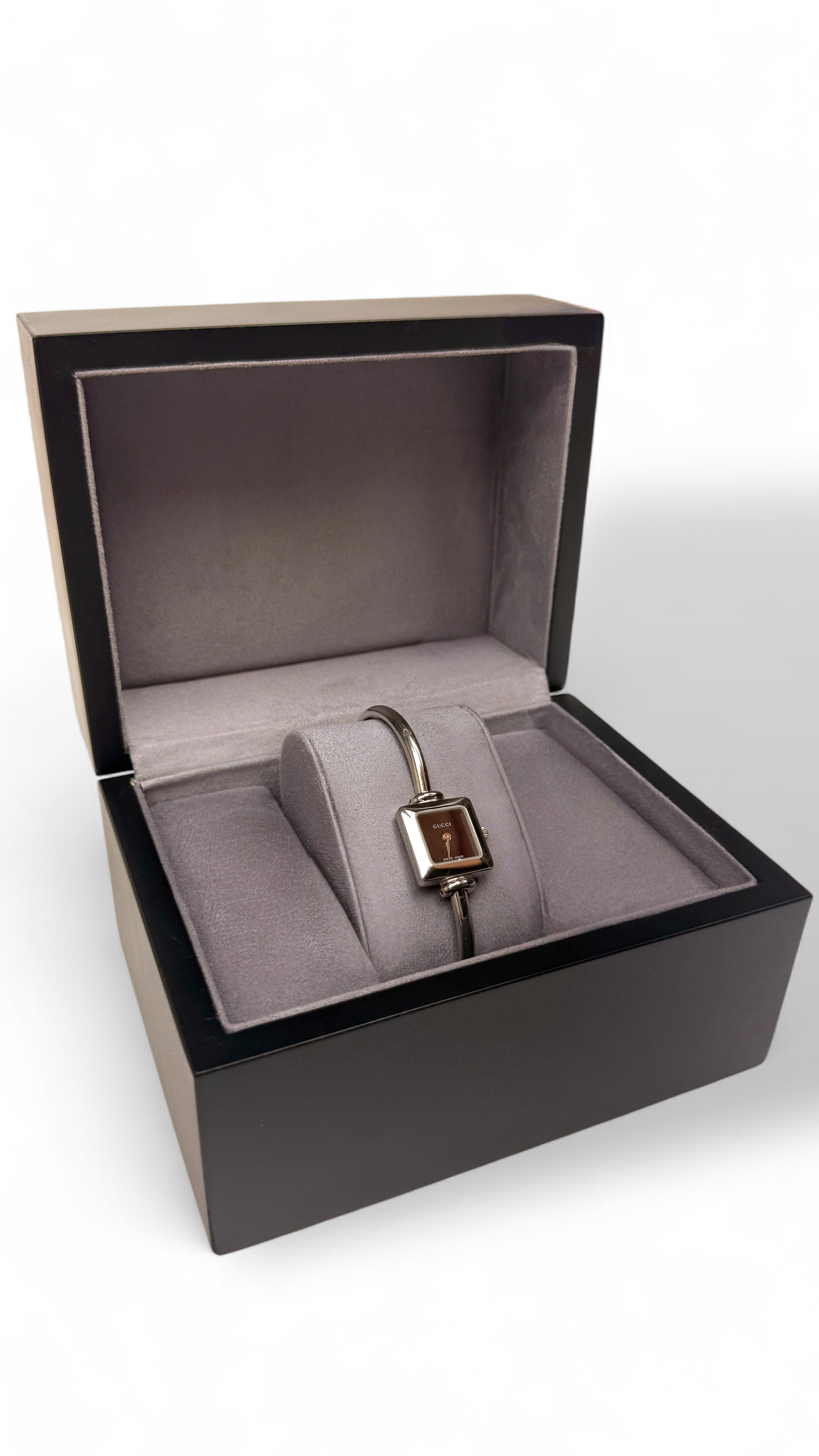 Jewelry box with a bracelet Gucci watch inside on a white background